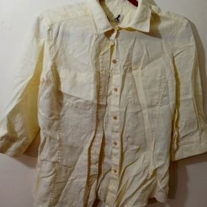 Button through pale yellow blouse.